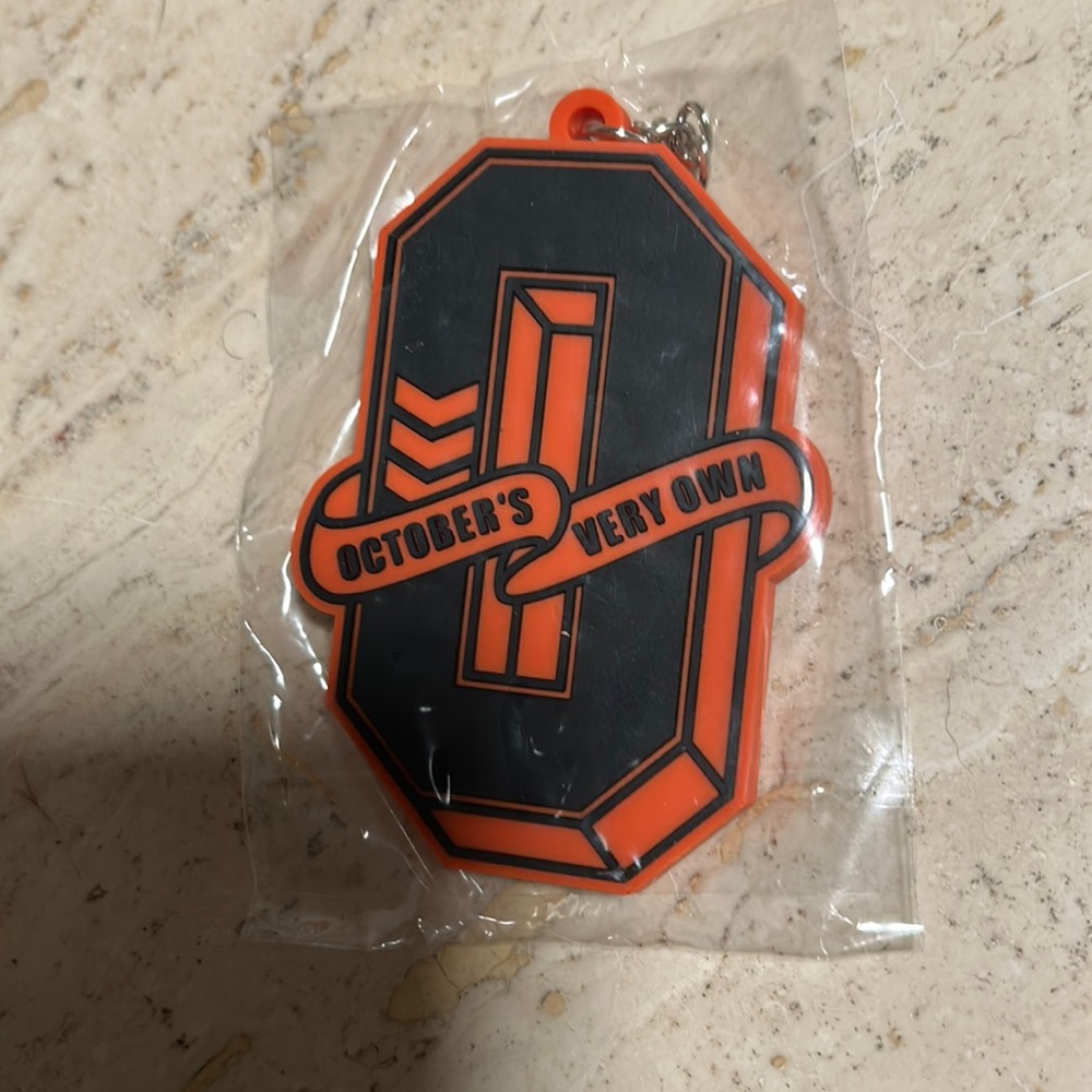 Silicone Drake ovo varsity monogram letter O keychain orange and black
